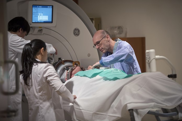 In this March 23, 2017 photo provided by the Sunnybrook Health Sciences Centre, patient Rick Karr is prepared for treatment at the facility in Toronto, Canada. Karr was the first Alzheimer’s patient treated with focused ultrasound to open the blood-brain barrier. (Kevin Van Paassen/Sunnybrook Health Sciences Centre via AP)