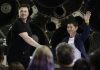 SpaceX founder and chief executive Elon Musk, left, shakes hands with Japanese billionaire Yusaku Maezawa, right, after announcing him as the first private passenger on a trip around the moon, in Hawthorne, Calif. (AP Photo/Chris Carlson)