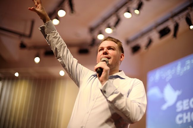 Jeremy Meddows-Taylors, Head of Music, Bromsgrove International School, conducts the whole choir during the practice for the choral day gala concert.
