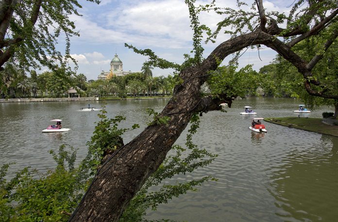Visitors paddle boats in a lake at Dusit Zoo, as the Ananta Samakhom Throne Hall in looms over them in the background. (AP Photo/Gemunu Amarasinghe)