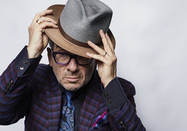 This Sept. 17, 2018 photo shows music legend Elvis Costello posing for a portrait at The Redbury New York hotel in New York to promote his latest release “Look Now.” (Photo by Matt Licari/Invision/AP)