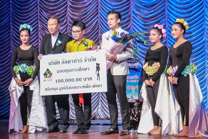 Alcazar Theater executive Pavin Petchtrakul presents a donation of 100,000 baht to Orphanage Director Rev. Veera Pangrak.