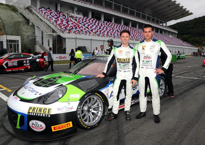 Thailand’s Sandy Stuvik (right) and teammate Shae Davies of Australia pose next to their Craft Bamboo Racing team Porsche 911 GT3 R at the Ningbo International Speedpark in the Zhejiang province of China, Saturday, October 13.