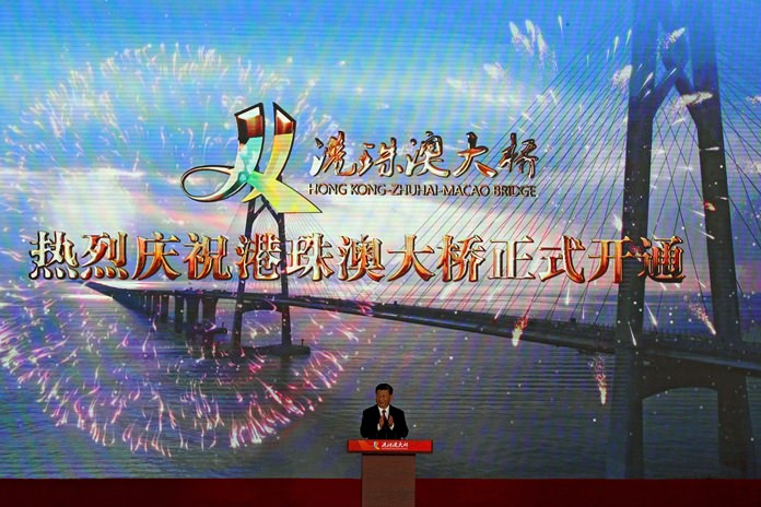 Chinese President Xi Jinping applauds on stage during the official opening of the China-Zhuhai-Macau-Hong Kong Bridge Tuesday, Oct. 23, 2018. (AP Photo/Andy Wong)