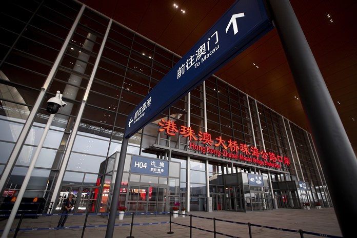 A security officer stands guard at the main entrance of the immigration building for the China-Zhuhai-Macau-Hong Kong Bridge ahead of the opening ceremony in Zhuhai in south China’s Guangdong province, Tuesday, Oct. 23. (AP Photo/Andy Wong)