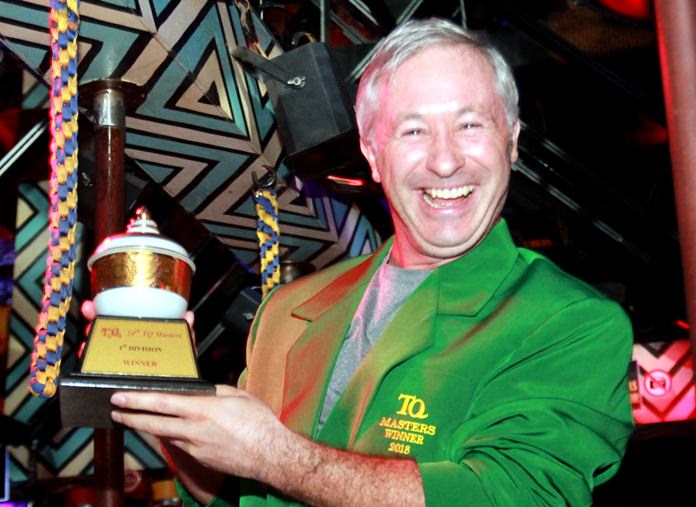 Richard Anderson wears the Green Jacket and holds his trophy after winning the 23rd annual T.Q. Masters golf classic.