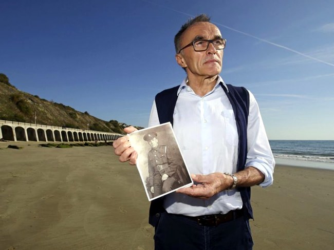 British filmmaker Danny Boyle holds a photograph of Private Walter Bleakley, who lived on the same street where Boyle went to school, as he announces plans for his Armistice Day First World War centenary commemoration, on the beach, in Folkestone, England, Friday Oct. 5. (Gareth Fuller/PAvia AP)
