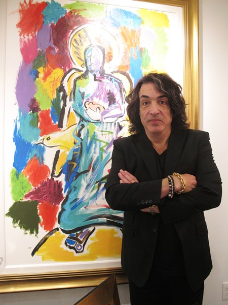 In this Oct. 13, 2018 photo, Paul Stanley, singer and guitarist for the rock group Kiss, poses next to his artwork at a gallery in Atlantic City, N.J. (AP Photo/Wayne Parry)
