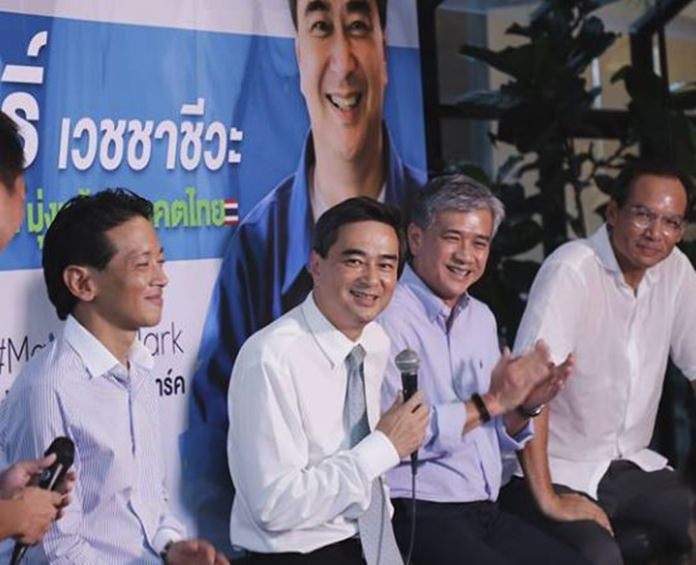 Former Prime Minister Abhisit Vejjajiva (2nd left) speaks at a political gathering.
