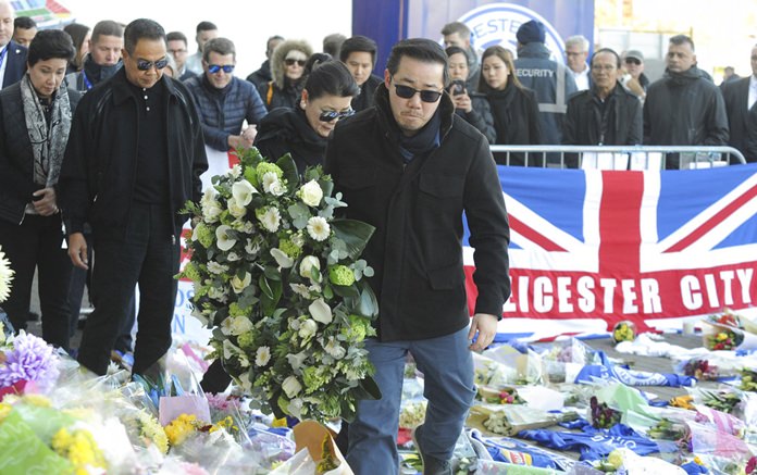 Aiyawatt Srivaddhanaprabha, the son of Vichai Srivaddhanaprabha, and his mother Aimon, center left, lay a wreath with family members outside Leicester City Football Club in Leicester, England, Monday Oct. 29. (AP Photo/Rui Vieira)