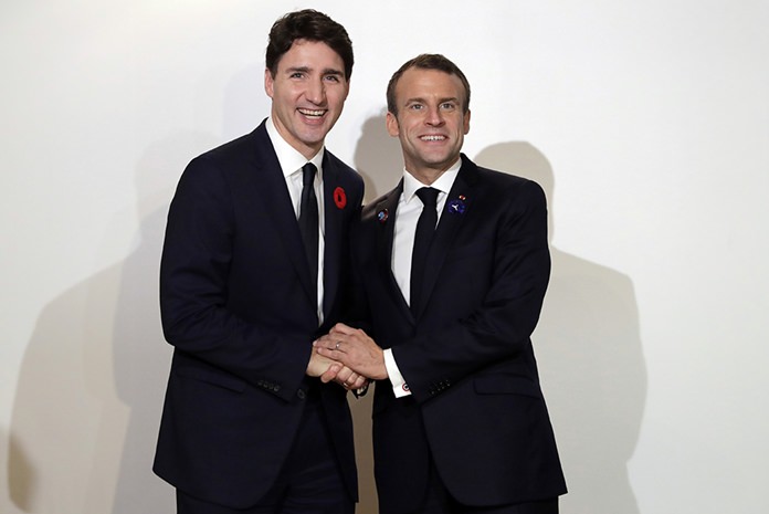 French President Emmanuel Macron, right, meets Canadian Prime Minister Justin Trudeau at the Paris Peace Forum in Paris, Sunday, Nov.11, 2018. (Thomas Samson, Pool via AP)
