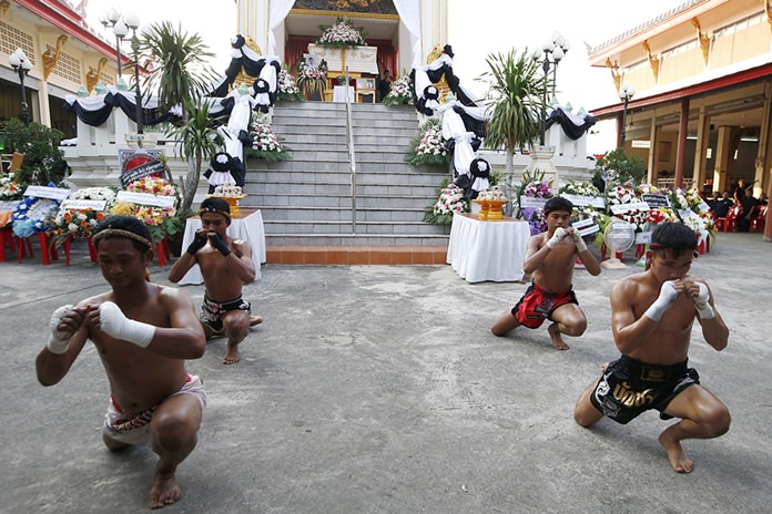 Thai boxers perform their traditional dance showing respect at the coffin of 13-year-old Thai kickboxer Anucha Tasako during his funeral services. (AP Photo/Sakchai Lalit)