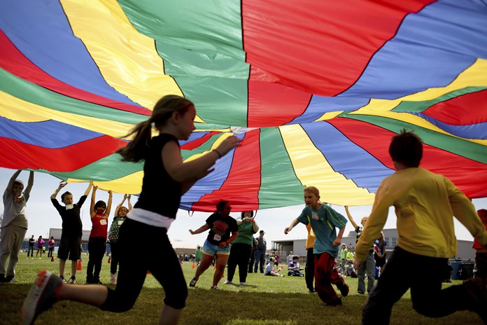New federal guidelines released on Monday, Nov. 12, 2018, advise that children as young as age 3 should move more, sit less and get more active, and that any amount and any type of exercise helps health. (Aaron Marineau/The Hutchinson News via AP)