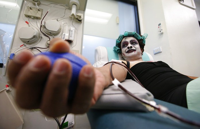 Thanat Chotrat dressed in a ghost costume for Halloween donates blood at the Thai Red Cross in Bangkok, Wednesday, Oct. 31. (AP Photo/Sakchai Lalit)