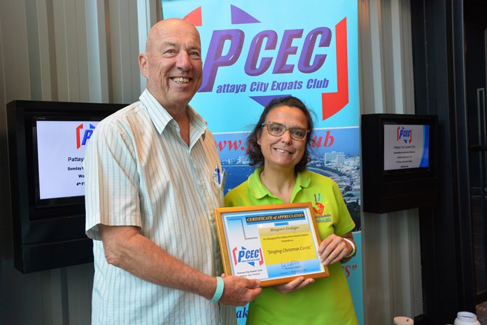MC Roy Albiston presents Margie Grainger with the PCEC’s Certificate of Appreciation for bringing some of the Hand to Hand Foundation children to entertain with an early Christmas program.