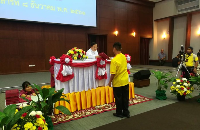 Father Ray Foundation Vice President Michael Picharn Jaiseri hands a diploma to one the 72 graduates of the Pattaya Redemptorist Technological College for Persons with Disabilities.