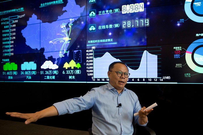 Ding Xiaohua, deputy director of the Shanghai Electric Vehicle Public Data Collecting, Monitoring and Research Center speaks near a data display screen in Shanghai, China. (AP Photo/Ng Han Guan)