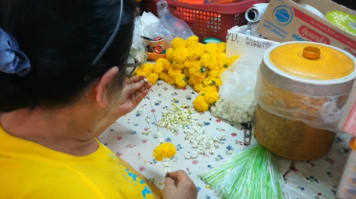 A woman lovingly and painstakingly creates a jasmine flower garland for Fathers’ Day.