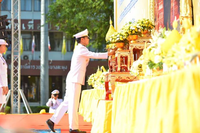 Banglamung District Chief Amnart Charoensri makes an offering of flowers and incense in front of a portrait the late HM Rama IX.