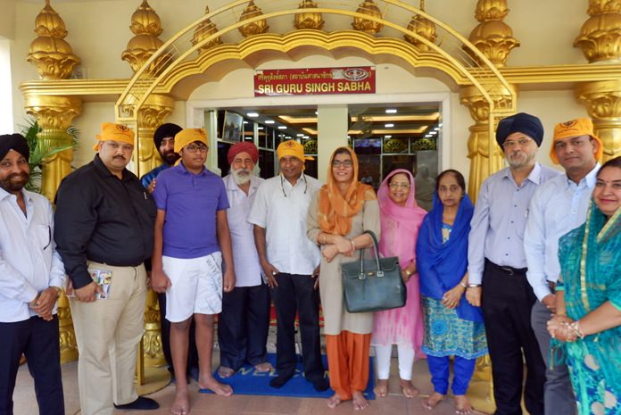 H.E. Mrs. Suchitra Durai and her husband former ambassador R. Swaminathan pose for a photo in front of the Sri Guru Singh Sabha Sikh Temple.