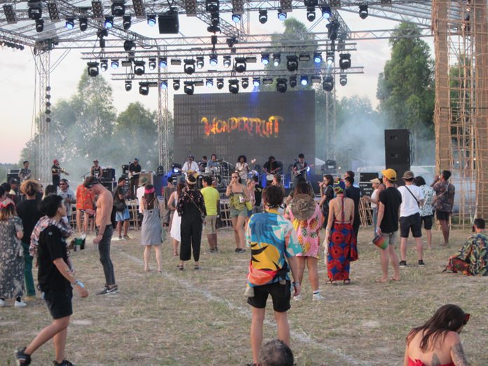 Smoke drifts across the stage as festival goers enjoy live music at the 5th Wonderfruit Festival in Pattaya.