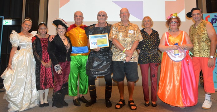 MC Roy Albiston poses with the cast of Pattaya Players Puss in Boots pantomime after presenting them with the PCEC’s Certificate of Appreciation.