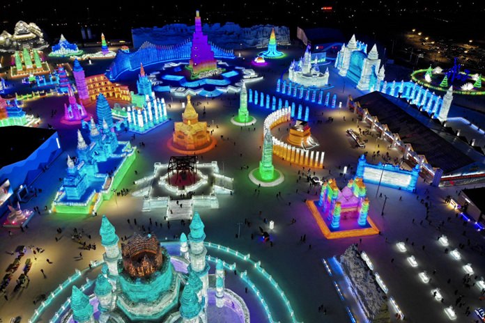 An aerial view taken with a drone shows the colorful building structures made from blocks of ice at the Harbin International Ice and Snow festival held in Harbin, China, Friday, Jan. 4.
