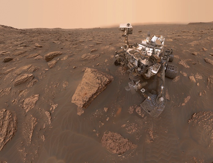 This composite image made from a series of June 15, 2018 photos shows a self-portrait of NASA’s Curiosity Mars rover in the Gale Crater. The rover’s arm which held the camera was positioned out of each of the dozens of shots which make up the mosaic. A dust storm has reduced sunlight and visibility at the rover’s location. (NASA/JPL-Caltech via AP)