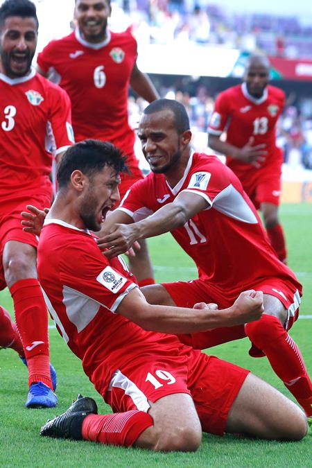 Jordan’s defender Anas Bani Yaseen (front left) celebrates with teammates after scoring the winning goal against Australia in their AFC Asian Cup group B match in Al Ain, UAE, Sunday, Jan. 6. (AP Photo/Hassan Ammar)