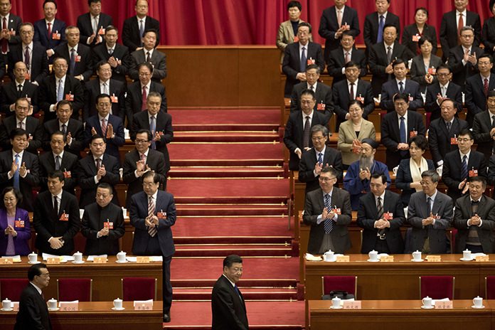 Chinese President Xi Jinping, center, arrives with Premier Li Keqiang, left, for the opening session of the Chinese People’s Political Consultative Conference in Beijing’s Great Hall of the People on March 3, 2018. (AP Photo/Ng Han Guan)