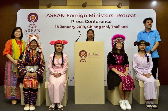 Thai school children in traditional tribal attire sit on cardboard chairs during a symbolic ceremony to receive cardboard school chairs made of recycled paper following the Association of Southeast Asian Nations (ASEAN) Foreign Ministers’ retreat in Chiang Mai. (AP Photo/Gemunu Amarasinghe)