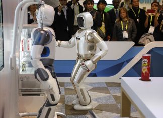 The Walker robot grabs a soda can during a demonstration at the Ubtech booth at CES International, Wednesday, Jan. 9, 2019, in Las Vegas. (AP Photo/John Locher)