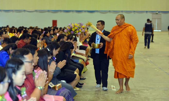 A revered monk blesses with holy water more than 4,000 area school teachers and educational administrators at the Teacher’s Day celebration inside the National Indoor Sports Area.