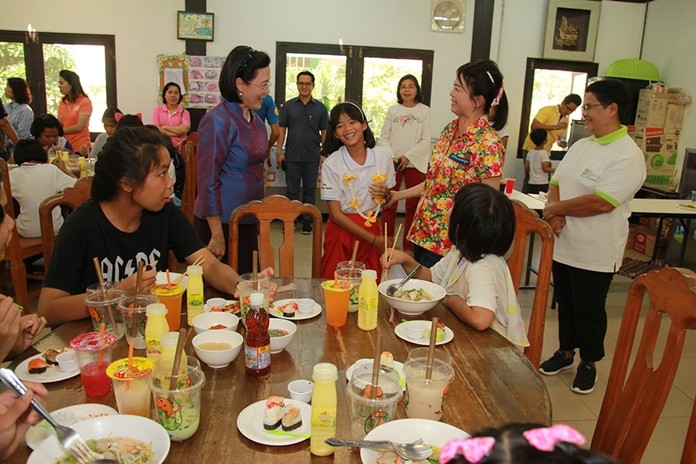Radchada Chomjinda and children welcome Supaporn Thienchai to the Children’s Day party at the Child Protection and Development Center.