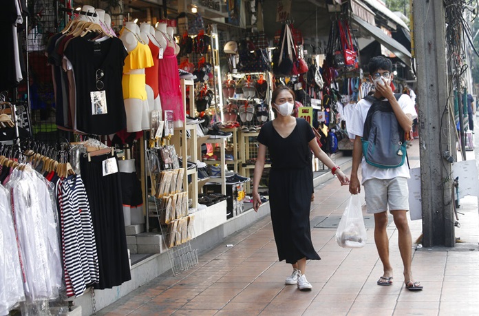 Pedestrians wear masks in the poor air quality of Bangkok, Thailand, Monday, Jan. 14. (AP Photo/Sakchai Lalit)