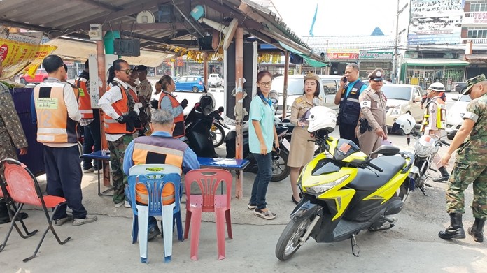 Soldiers and district officials check taxi stands in Sattahip.