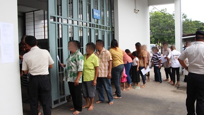 People line up to register to see family members at a recent family-visit day.
