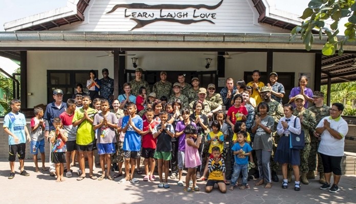 Sailors and Marines assigned to the amphibious transport dock ship USS Green Bay (LPD 20) pose for a group photo during a community service project at the Child Protection and Development Center in Chonburi.