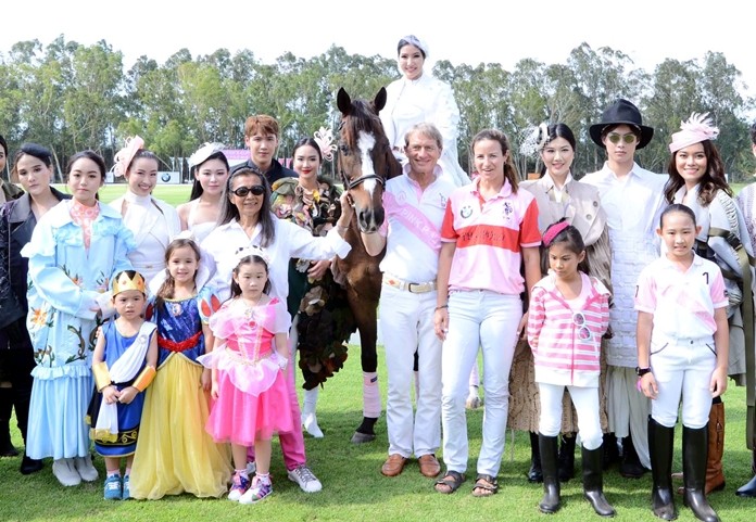 Dr. Harald Link, President of B.Grimm Group and President of the Thailand Equestrian Federation, center, and Ms.Nunthinee Tanner (wearing sunglasses in center), the chairman of organizing committee for Queen’s Cup Pink Polo, pose with celebrities and socialites at Queen’s Cup Pink Polo 2019.