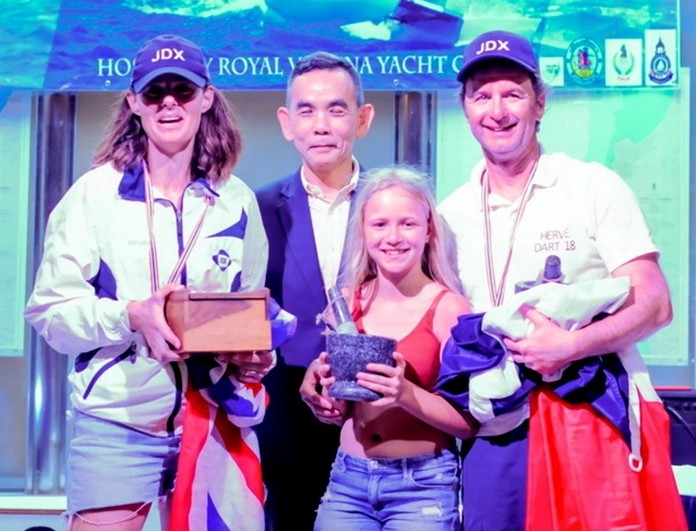 Rear-Admiral Wipan Chamachote (center) presents consolation awards to fourth placed Herve Le Maux and Nicola Davies with their young supporter.