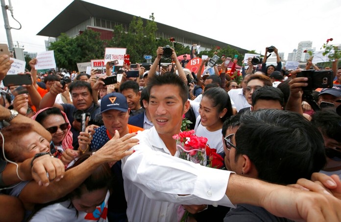 Future Forward Party leader Thanathorn Juangroongruangkit, center, is mobbed by his supporters upon arrival at a police station Bangkok, Saturday, April 6. (AP Photo/Sakchai Lalit)