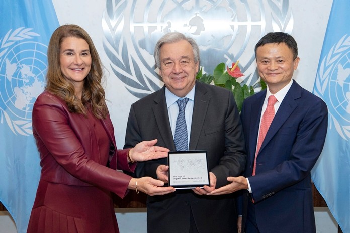 Melinda Gates and Jack Ma present United Nations Secretary-General Antonio Guterres, center, with the "The Age Digital of Digital Independence" report, at U.N. headquarters, Monday, June 10, 2019. (Eskinder Debebe/UN Photo via AP)