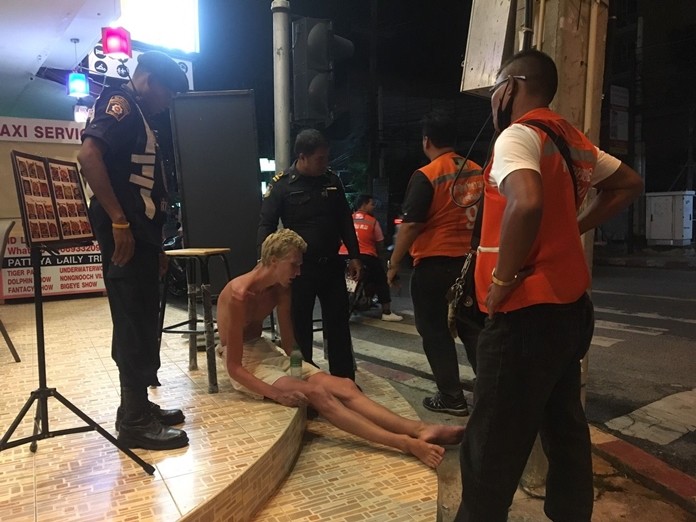 Police covered up a nearly emaciated naked foreigner standing in the middle of a South Pattaya road.