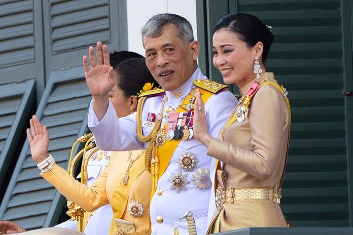 Their Majesties King Maha Vajiralongkorn and Queen Suthida wave to an audience from the balcony of Suddhaisavarya Prasad Hall in the Grand Palace during the coronation ceremony Monday, May 6, 2019, in Bangkok.