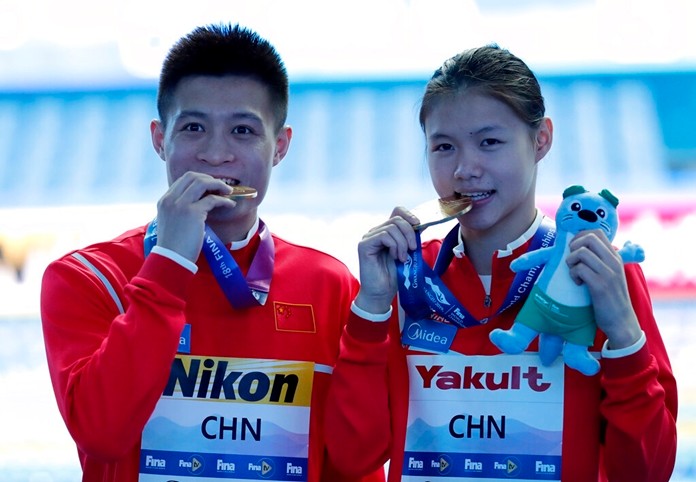 China's Lin Shan and Yang Jian pose with their gold medal after winning mixed team event diving final at the World Swimming Championships in Gwangju, South Korea, Tuesday, July 16, 2019. (AP Photo/Lee Jin-man )