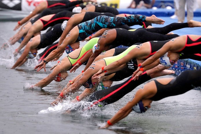 Swimmers leap into the water at the start of the 5km mixed relay open water swim at the World Swimming Championships in Yeosu, South Korea, Thursday, July 18, 2019. (AP Photo/Mark Schiefelbein)