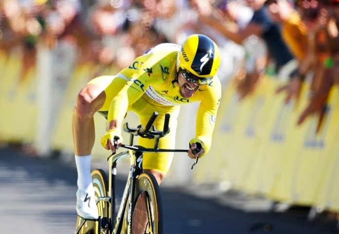 France's Julian Alaphilippe wearing the overall leader's yellow jersey crosses the finish line to win the thirteenth stage of the Tour de France cycling race, an individual time trial over 27.2 kilometers (16.9 miles) with start and finish in Pau, France, Friday, July 19, 2019. (AP Photo/Christophe Ena)