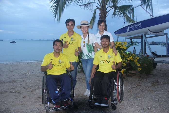 Three Thai national sailing male athletes from the Disabled Sailing Thailand and their lovely friends give thumbs up to the great project.