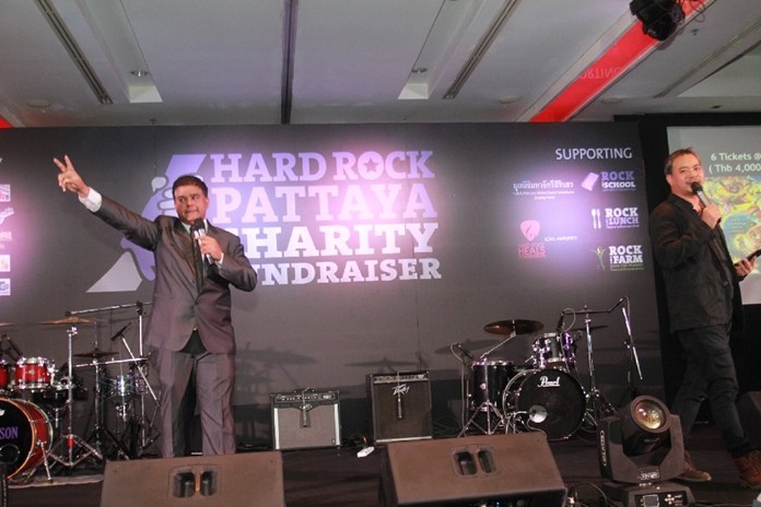 Tony Malhotra (left) and Kavee Suwannachartpan conduct the charity auction for many valued items, including a signed Parkinson guitar, hotel vouchers and more.