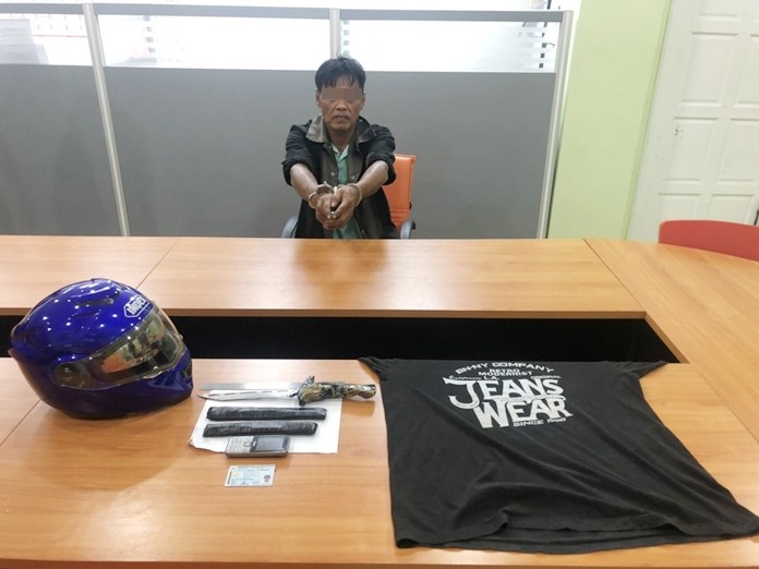 Kednarong Jansirinusorn, from Loei, sits in a police station after being arrested for the murder of a local language teacher.